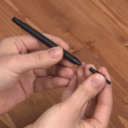 Person replacing nibs in Wacom stylus.